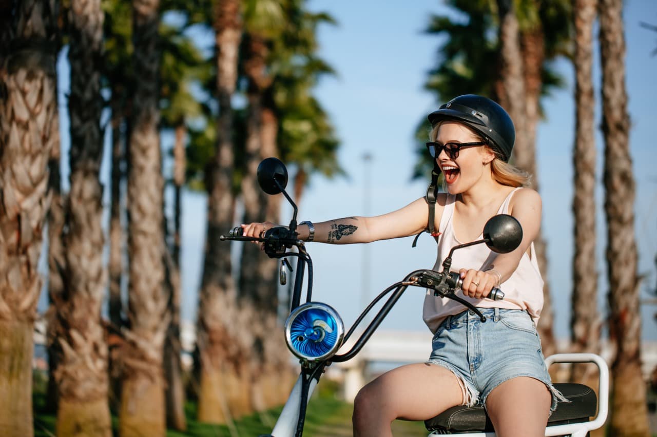 Woman on bike with palm trees